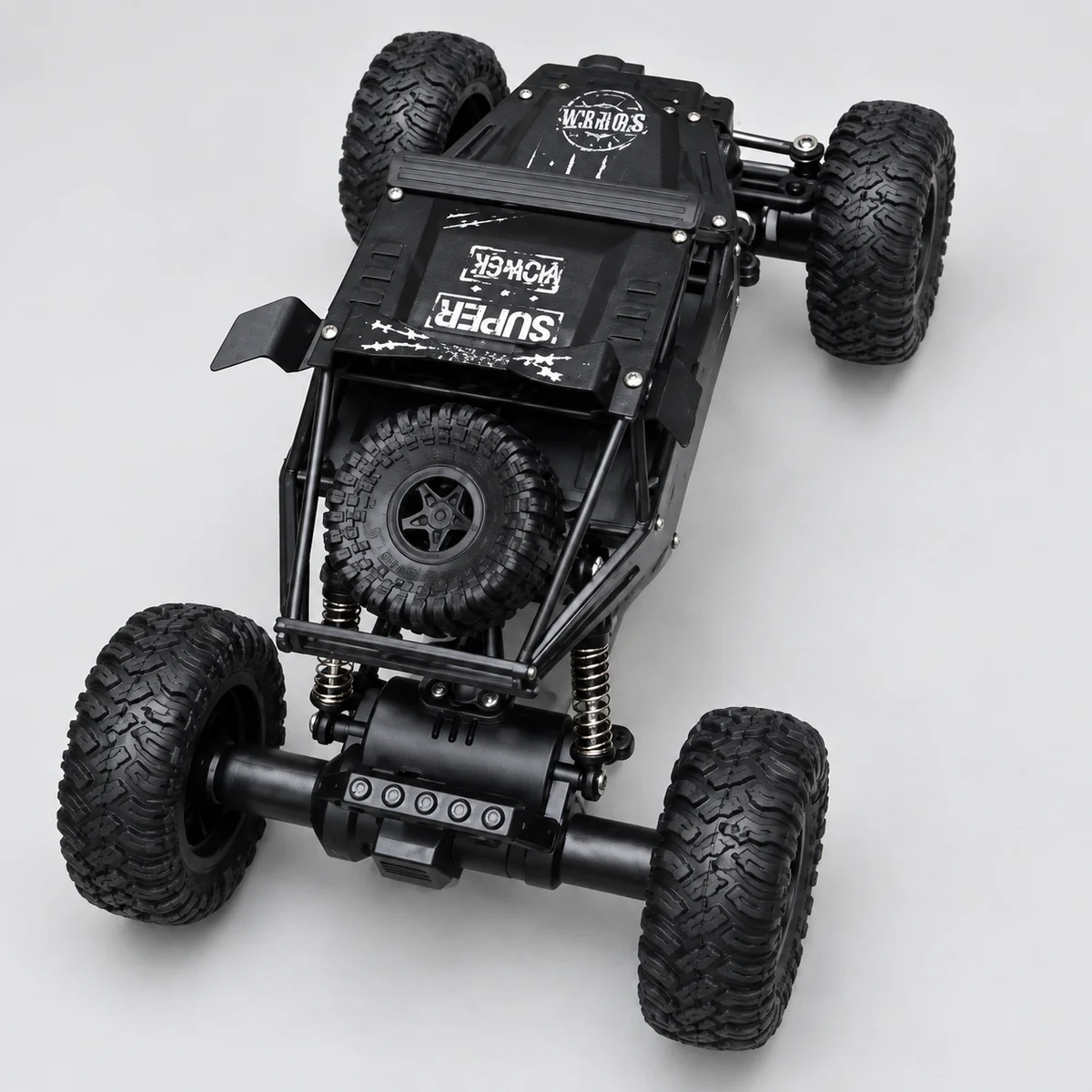 Top view of a black open-frame RC crawler with a top-mounted spare tyre